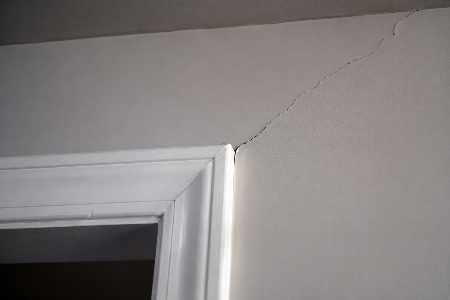 Diagonal settlement crack running up from the top corner of an interior door frame in Riverside, CA